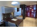 Modern kitchenette with stainless steel appliances, sleek cabinetry, and a stylish countertop for dining at 4381 W Flamingo Rd # 903, Las Vegas, NV 89103