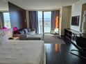 Comfortable room with large balcony, city views, a well-furnished living space, and entertainment center at 4381 W Flamingo Rd # 903, Las Vegas, NV 89103