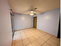 Bedroom featuring tile floors, ceiling fan, and a sliding glass door that provides natural light at 441 N Lamb Blvd # E, Las Vegas, NV 89110