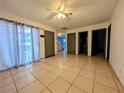 Spacious living room featuring tile floors, ceiling fan, and large window with translucent curtains at 441 N Lamb Blvd # E, Las Vegas, NV 89110