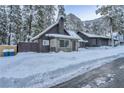 Cozy cabin has stone accents, surrounded by snow-covered landscape, blending rustic charm with winter beauty at 4587 Yellow Pine Ave, Mount Charleston, NV 89124