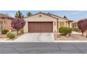 Inviting single-story home with a two-car garage and desert landscaping at 5928 Radiance Park St, North Las Vegas, NV 89081
