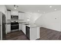 Well-lit kitchen boasts stainless steel appliances, sleek countertops, white cabinetry, and an open layout at 6252 Blood Lily Ave, Las Vegas, NV 89122