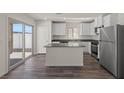 Bright kitchen featuring white cabinetry, stainless steel appliances, and a spacious center island at 6264 Blood Lily Ave, Las Vegas, NV 89122