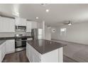 Open kitchen layout with a center island, stainless steel appliances, and a view of the living area at 6264 Blood Lily Ave, Las Vegas, NV 89122