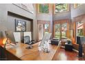 Stylish office space with high ceilings, large windows, and a wood desk at 7315 Mission Hills Dr, Las Vegas, NV 89113