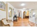 Upstairs living room with hardwood floors, decorative molding, and an elegant chair at 7682 Calm Passage Ct, Las Vegas, NV 89139