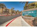 Welcome to Raintree West, gated community, surrounded by lush landscaping and mature palm trees under clear blue sky at 7950 W Flamingo Rd # 1081, Las Vegas, NV 89147