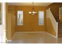 Open dining area with tile flooring, staircase, and natural lighting at 8003 Retriever Ave, Las Vegas, NV 89147