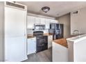 Bright kitchen featuring appliances, white cabinets, and light wood countertops at 1381 E University Ave # 204, Las Vegas, NV 89119