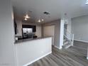 Modern kitchen boasts stainless steel appliances and granite countertops, with convenient access to the staircase at 2504 Trustworthy Ave, North Las Vegas, NV 89031