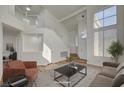 Bright, airy living room with high ceilings, white walls, and a staircase at 2573 Rafferty Creek Ln, Las Vegas, NV 89156