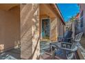 Inviting covered porch with comfortable seating and a decorative front door, perfect for relaxing at 283 New River Cir, Henderson, NV 89052