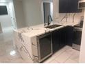 A modern kitchen featuring a marble countertop island, dark blue cabinets, and stainless steel appliances at 2970 Juniper Hills Blvd # 102, Las Vegas, NV 89142