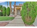 Inviting front entrance with manicured landscaping and an elegant wrought iron security door at 3367 Trickling Stream Cir, Las Vegas, NV 89117