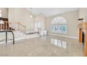 Spacious living room with vaulted ceilings, tiled floors, and large windows with plantation shutters at 3367 Trickling Stream Cir, Las Vegas, NV 89117