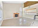 Bright living room with fireplace, tile floors, and large windows providing ample natural light at 3367 Trickling Stream Cir, Las Vegas, NV 89117