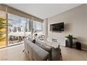 Bright living room with city views, stylish furnishings, and entertainment center at 3726 Las Vegas Blvd # 303, Las Vegas, NV 89158