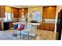 Spacious kitchen featuring granite countertops, a large island with seating, and ample cabinet space at 4488 Mission Meadow Cir, Las Vegas, NV 89139