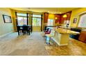 Modern kitchen with stainless steel appliances, large island with bar seating, and adjacent dining area at 4488 Mission Meadow Cir, Las Vegas, NV 89139