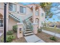 Apartment exterior featuring stairs leading to the second floor with landscaped surroundings and covered parking spots at 4861 S Torrey Pines Dr # 201, Las Vegas, NV 89103