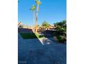 Paver patio with turf and palm trees create a relaxing and luxurious outdoor living space at 5568 Yellow Ash St, Las Vegas, NV 89118