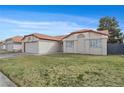 Charming single-story home with a well-maintained lawn and a two-car garage at 6413 Chippindale Ln, Las Vegas, NV 89108