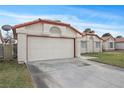 Exterior view of a two-car garage, with lawn and a peek of the home next door at 6413 Chippindale Ln, Las Vegas, NV 89108