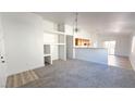 View of the living room that features fresh white paint and new carpets at 6533 Adonis Heights Ave, North Las Vegas, NV 89086