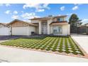 Two-story home with a distinctive lawn pattern at 6775 Segura Dr, Las Vegas, NV 89103