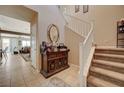 Inviting foyer with tile flooring, staircase and decorative furnishings at 7815 Red Rock Ridge Ave, Las Vegas, NV 89179
