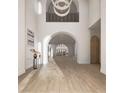 Bright, airy foyer with soaring ceilings, hardwood floors, archways, and a modern chandelier at 8 Via Verona Ct, Henderson, NV 89011