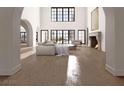 Open living room featuring high ceilings, a fireplace, and large windows at 8 Via Verona Ct, Henderson, NV 89011