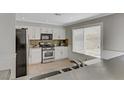 Well-lit kitchen featuring stainless appliances and tile flooring at 8313 Sky Canyon Ct, Las Vegas, NV 89128