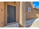 The front entry has a textured wall finish, a modern door and matching hardware at 9241 Placer Bullion Ave, Las Vegas, NV 89178