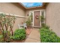 Inviting front porch area with greenery, decor, and a charming seating arrangement at 1433 Erskine Ave, Las Vegas, NV 89123