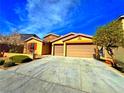 Beautiful single-story home with a two-car garage and a well-maintained yard at 1630 Meadow Bluffs Ave, Henderson, NV 89014
