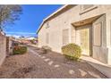 Inviting entrance way to the home features desert landscaping and a private courtyard at 258 Spring River Ave, Las Vegas, NV 89123