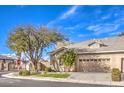 Single story home with a two-car garage, lush front lawn, and a corner lot at 258 Spring River Ave, Las Vegas, NV 89123