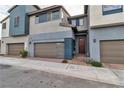 Attractive townhouse showcasing modern design with a two-car garage and stylish entrance at 2699 Chance Canyon St, Henderson, NV 89044
