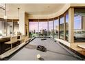 Chic interior featuring a pool table with panoramic city views through expansive windows at 360 E Desert Inn Rd # 404, Las Vegas, NV 89109