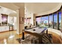 Open-concept living space with pool table and city views next to modern kitchen at 360 E Desert Inn Rd # 404, Las Vegas, NV 89109