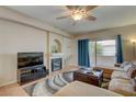 Cozy living room featuring a fireplace, ceiling fan, and sliding glass doors leading to outdoor space at 3600 Pierida St # 201, Las Vegas, NV 89108