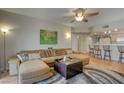 Spacious living room with a ceiling fan, and a view to the kitchen at 3600 Pierida St # 201, Las Vegas, NV 89108