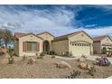 Charming single-story home with a well-manicured desert landscape, arched entry, and a two-car garage at 538 Cypress Gardens Pl, Henderson, NV 89012