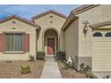 Close-up of the home's entry, showcasing the arched doorway, desert landscaping, and address number at 538 Cypress Gardens Pl, Henderson, NV 89012