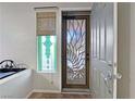Stylish entry with a decorative glass door and artistic window at 6437 Boatbill St, North Las Vegas, NV 89084