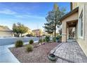 Landscaped front yard with rock garden, brick walkway, and view of the neighborhood at 6437 Boatbill St, North Las Vegas, NV 89084