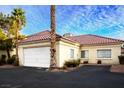 View of the home's side showing the garage and large windows at 726 Sea Pines Ln, Las Vegas, NV 89107