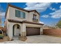 Two-story stucco home offering an arched entrance, a two car garage, and a concrete driveway at 7530 Brisa Del Mar Ave, Las Vegas, NV 89179
